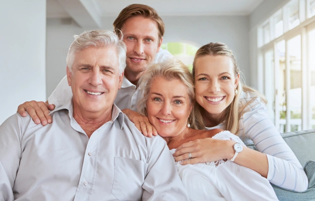 Multigenerational family smiling together after dental care at North Frisco Dental & Orthodontics