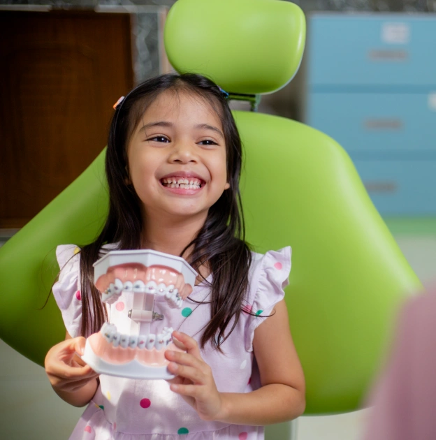 Young girl smiling in dental chair at North Frisco Dental & Orthodontics in Frisco, TX